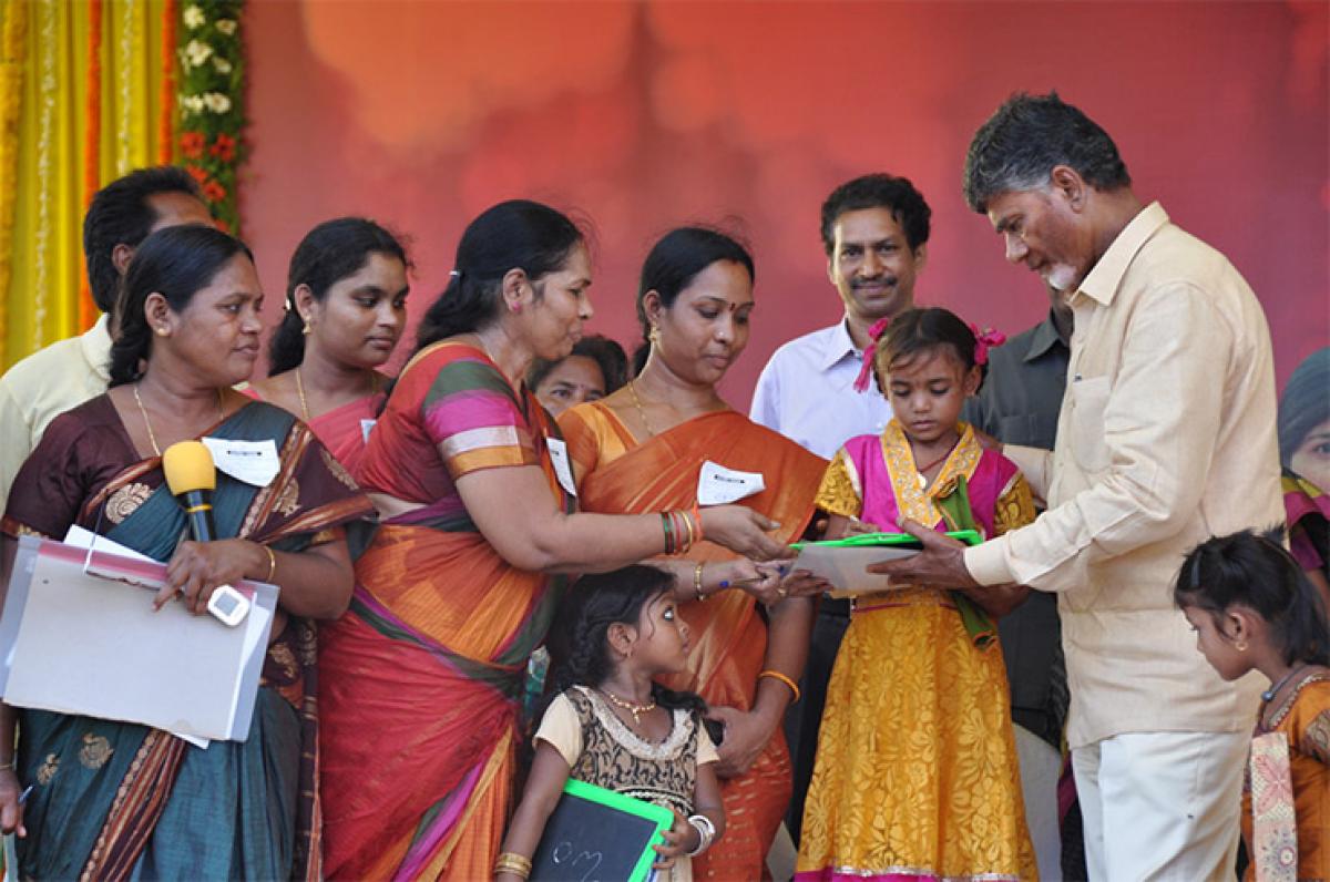 Chief Minister N Chandrababu performs Akhsharabhyasam  to girl children at the Janma Bhoomi venue in Chebrolu village in East Godavari district on Thursday